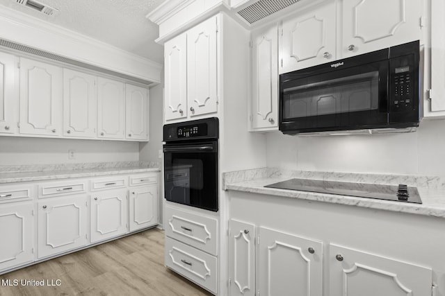 kitchen with white cabinetry, black appliances, crown molding, and light wood-type flooring