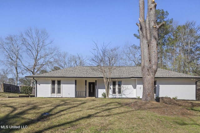 ranch-style home with brick siding, a shingled roof, a front yard, and fence