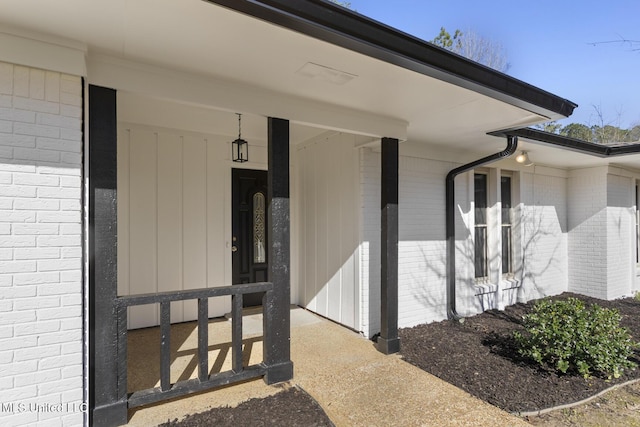 property entrance featuring brick siding