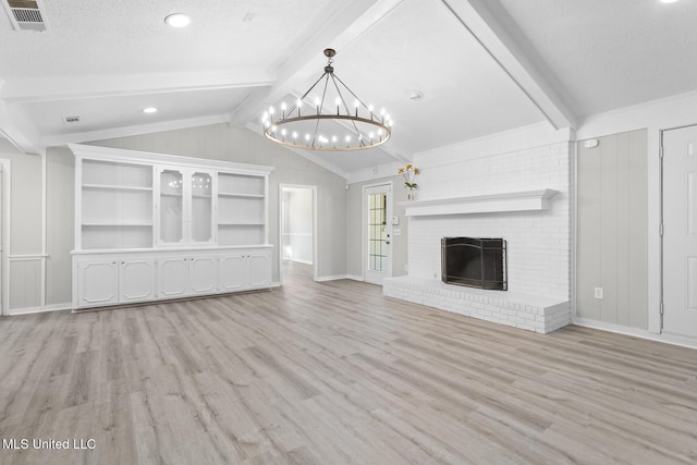 unfurnished living room featuring visible vents, a chandelier, lofted ceiling with beams, a fireplace, and a textured ceiling