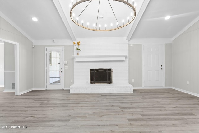 unfurnished living room featuring wood finished floors, vaulted ceiling with beams, and a fireplace