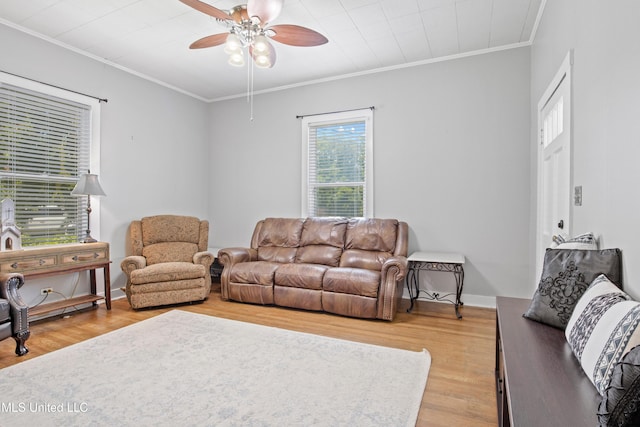 409 Coleman St, Como, MS 38619 - living area with wood finished floors, ornamental molding, and a ceiling fan