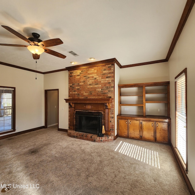 unfurnished living room with ornamental molding, a fireplace, light colored carpet, and ceiling fan