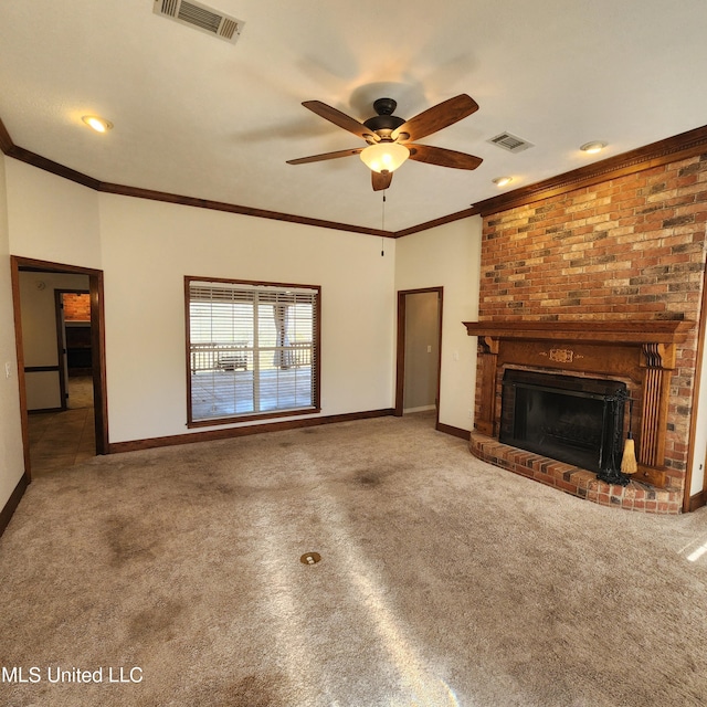 unfurnished living room featuring crown molding, ceiling fan, carpet floors, and a brick fireplace