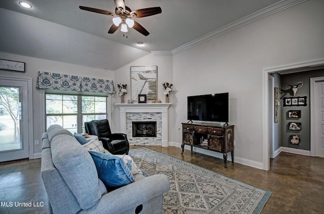 living room with a fireplace, baseboards, ceiling fan, finished concrete floors, and vaulted ceiling