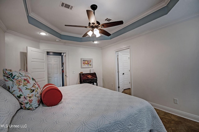 bedroom with visible vents, recessed lighting, crown molding, and a tray ceiling