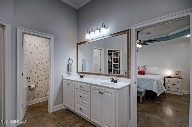 ensuite bathroom with crown molding, baseboards, ensuite bathroom, ceiling fan, and a sink
