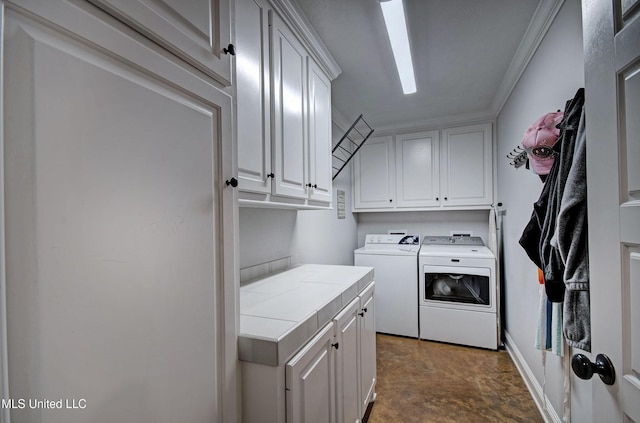 washroom with cabinet space and separate washer and dryer