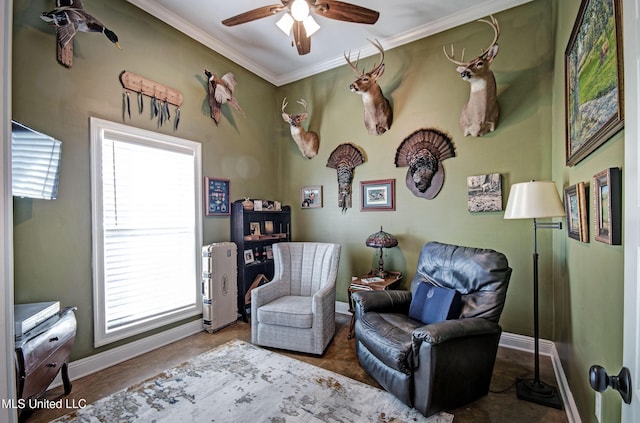 living area featuring baseboards, crown molding, and ceiling fan