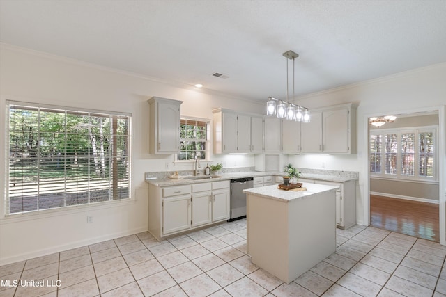 kitchen with stainless steel dishwasher, a kitchen island, light tile patterned floors, and plenty of natural light