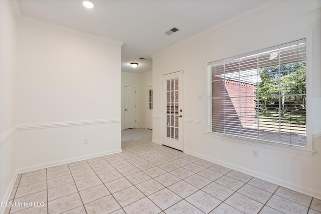 unfurnished room featuring ornamental molding and light tile patterned flooring