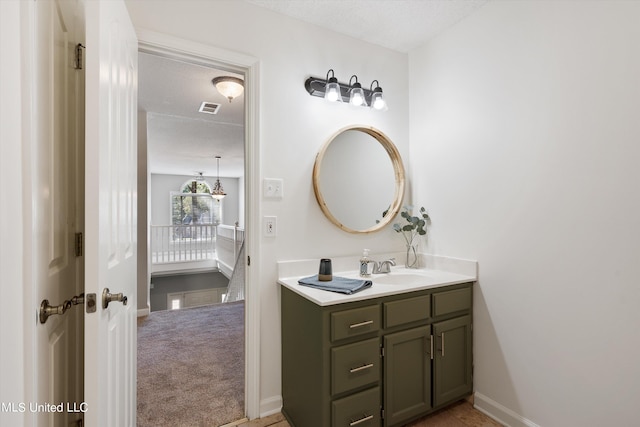 bathroom featuring vanity and a textured ceiling