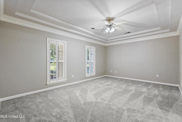 empty room featuring carpet flooring, ornamental molding, and a tray ceiling