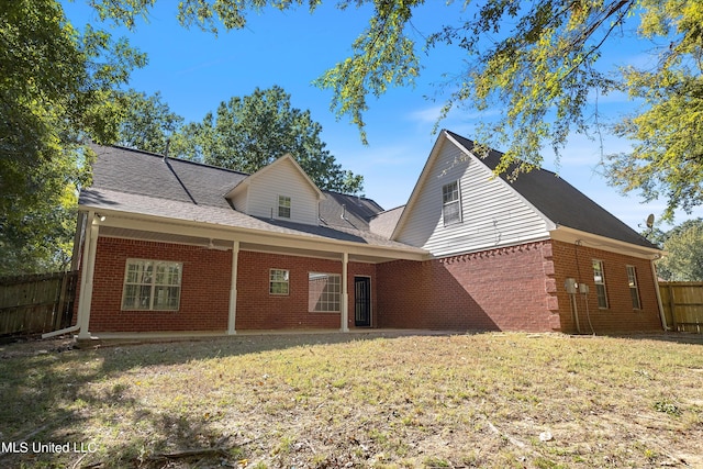 back of property featuring a yard