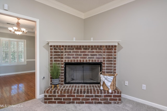 room details featuring crown molding, hardwood / wood-style floors, a chandelier, and a fireplace