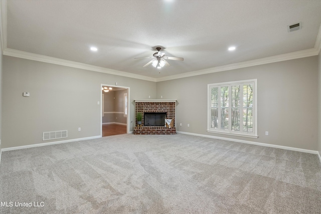 unfurnished living room featuring ornamental molding, carpet, a brick fireplace, and ceiling fan