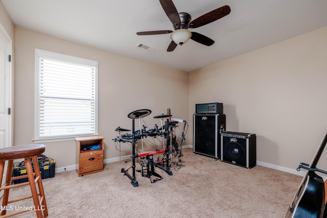 exercise room featuring light carpet and ceiling fan