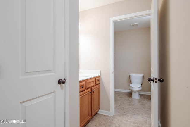 bathroom featuring toilet and vanity