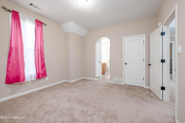 unfurnished bedroom with light colored carpet