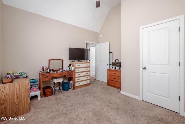 office space with light carpet and high vaulted ceiling