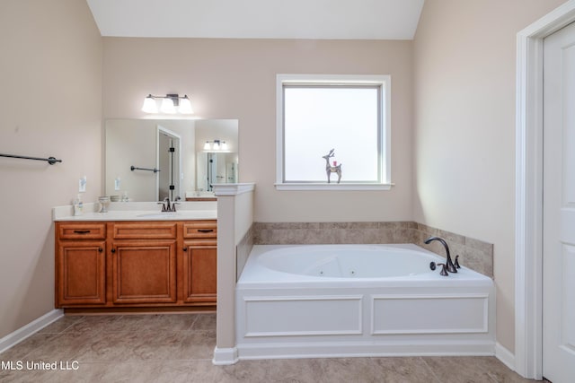 bathroom featuring vanity and a washtub