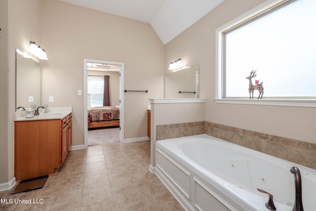 bathroom featuring tile patterned flooring, vanity, vaulted ceiling, and a bath