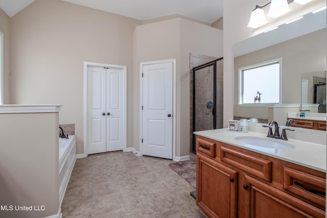 bathroom featuring shower with separate bathtub and vanity