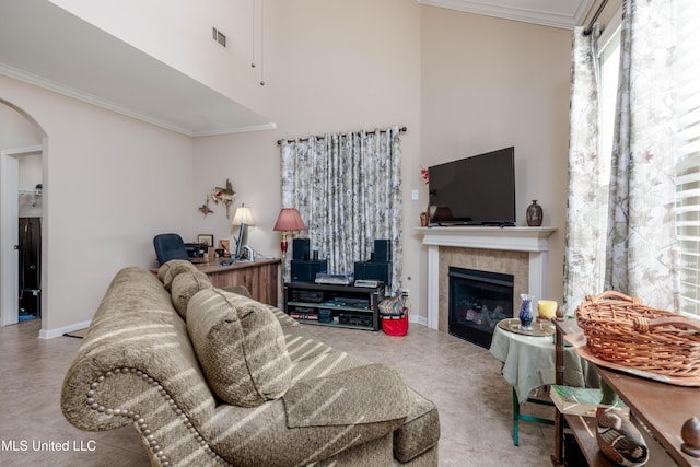 tiled living room featuring ornamental molding and a tile fireplace