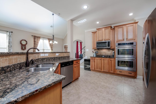 kitchen with appliances with stainless steel finishes, tasteful backsplash, hanging light fixtures, ornamental molding, and sink