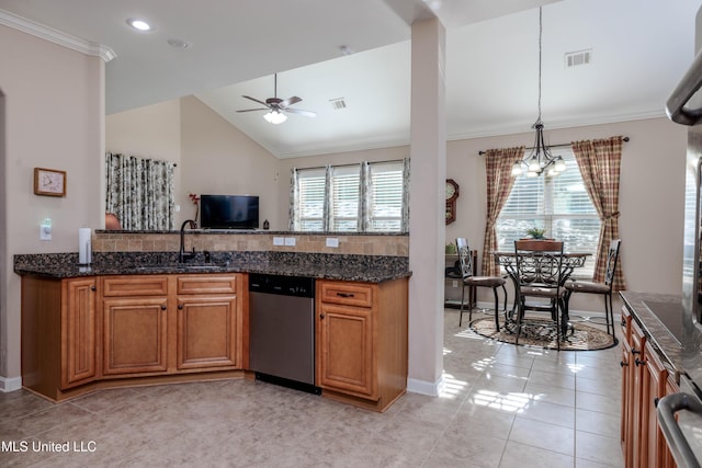 kitchen with decorative light fixtures, dishwasher, sink, and dark stone countertops