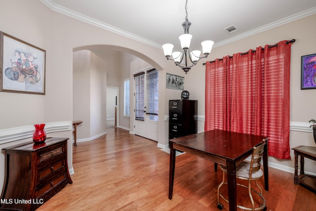 office featuring light hardwood / wood-style floors, ornamental molding, and a chandelier