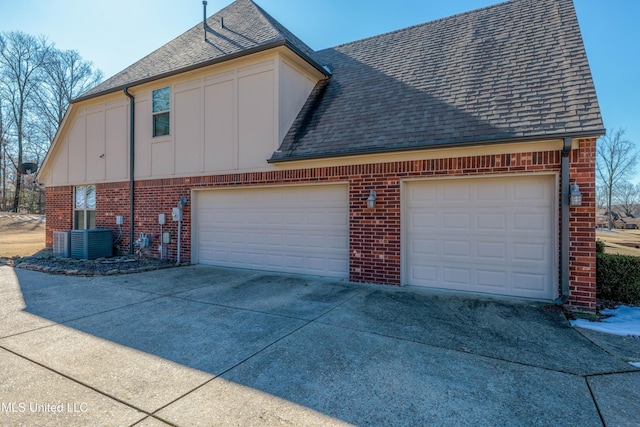 7419 Rose Garden Ln, Olive Branch, MS 38654 - view of side of property featuring brick siding, concrete driveway, board and batten siding, and roof with shingles