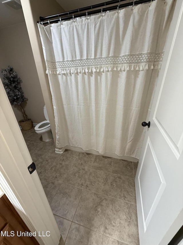 7419 Rose Garden Ln, Olive Branch, MS 38654 - bathroom with toilet, tile patterned flooring, and a shower with shower curtain