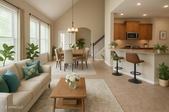 7419 Rose Garden Ln, Olive Branch, MS 38654 - living area with a chandelier, baseboards, recessed lighting, lofted ceiling, and arched walkways