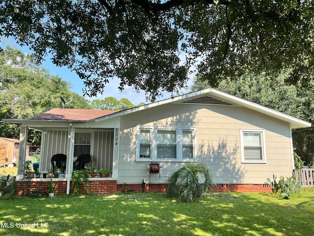 rear view of house with a lawn