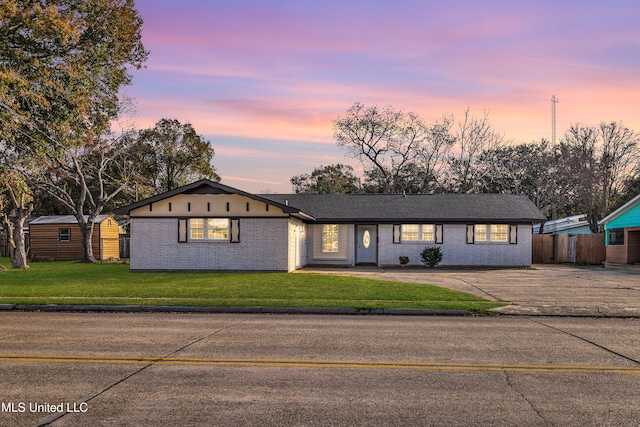 single story home with a yard