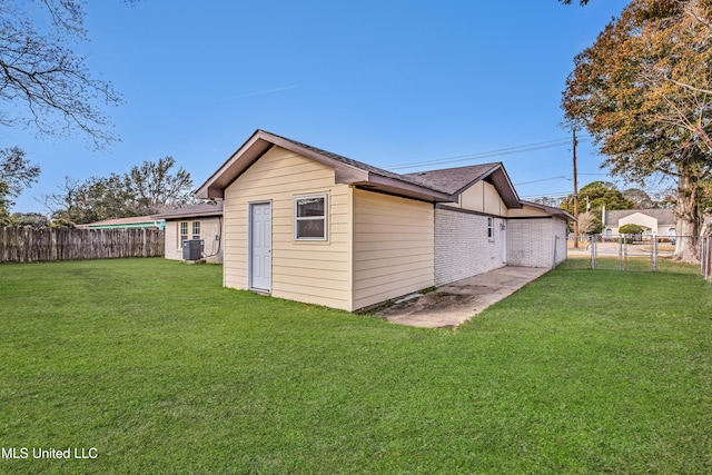 exterior space featuring a yard and central air condition unit