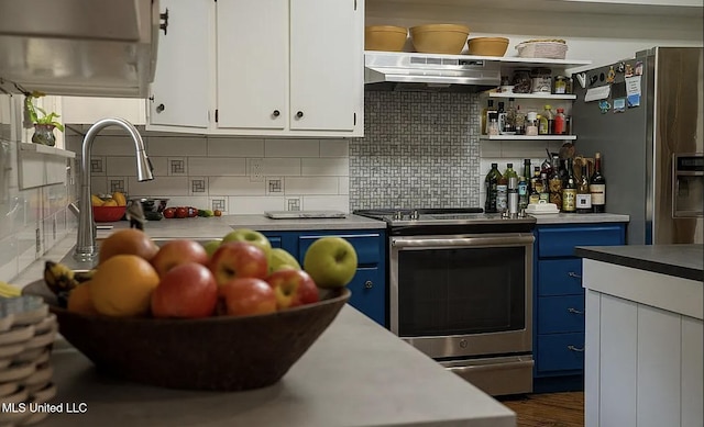 305 Dettor St, Batesville, MS 38606 - kitchen featuring blue cabinetry, under cabinet range hood, appliances with stainless steel finishes, white cabinets, and backsplash