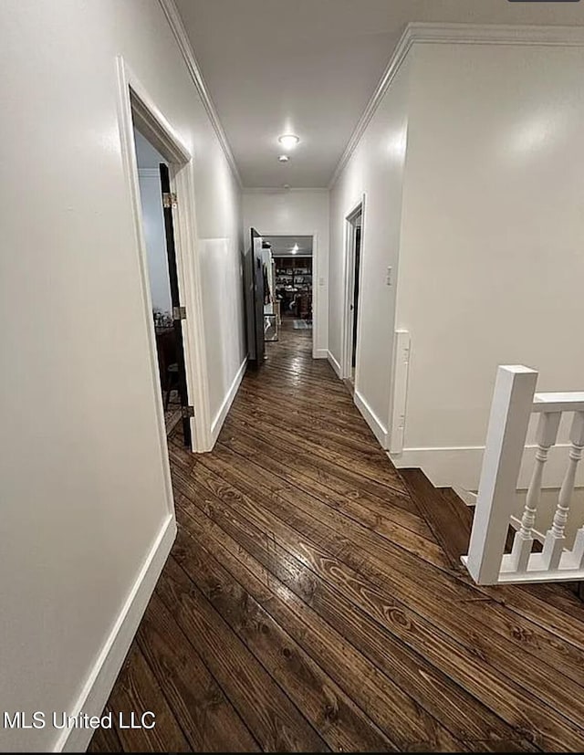 305 Dettor St, Batesville, MS 38606 - corridor featuring dark wood finished floors, crown molding, baseboards, and an upstairs landing