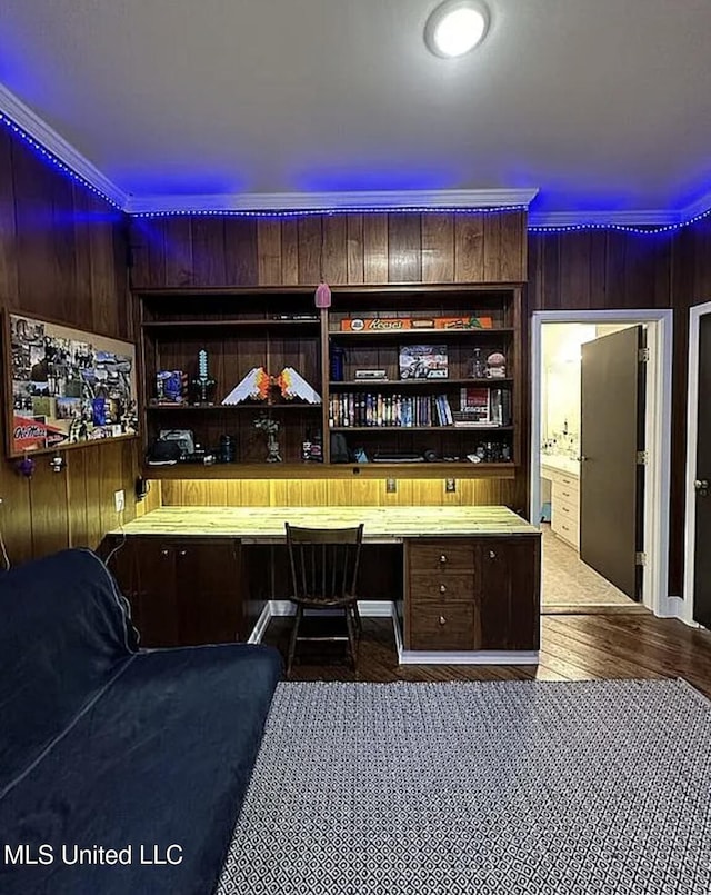 305 Dettor St, Batesville, MS 38606 - bar featuring built in desk, wooden walls, ornamental molding, and dark wood finished floors