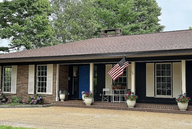305 Dettor St, Batesville, MS 38606 - view of front of home featuring a porch, roof with shingles, a chimney, and brick siding