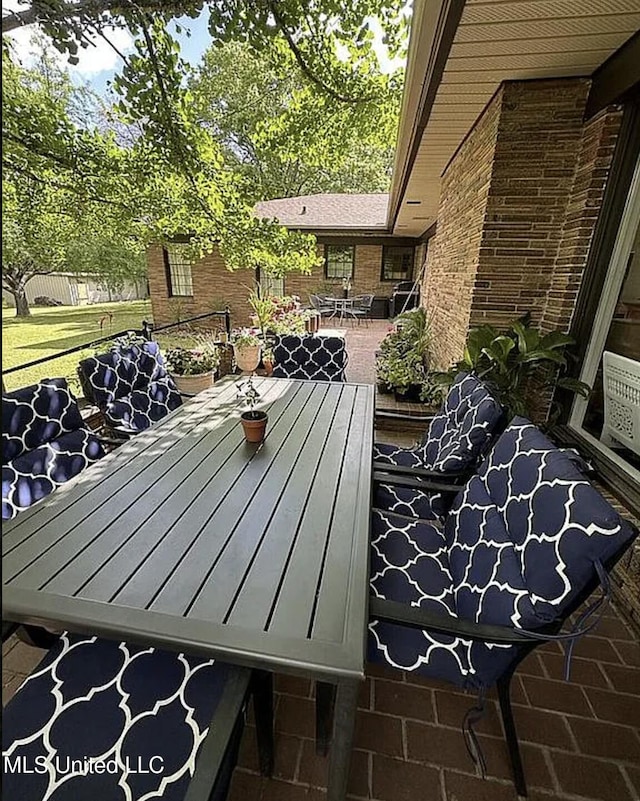 305 Dettor St, Batesville, MS 38606 - wooden deck featuring outdoor dining space and a patio area