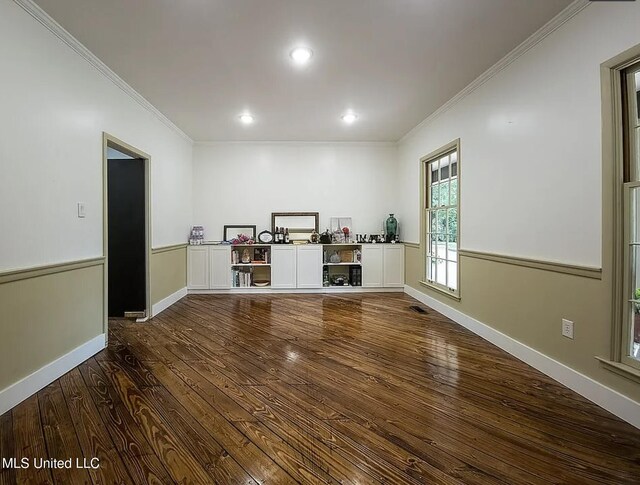 305 Dettor St, Batesville, MS 38606 - unfurnished living room featuring dark wood-style flooring, ornamental molding, recessed lighting, and baseboards