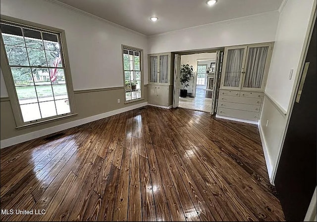 305 Dettor St, Batesville, MS 38606 - spare room featuring crown molding, dark wood-type flooring, a wainscoted wall, and baseboards