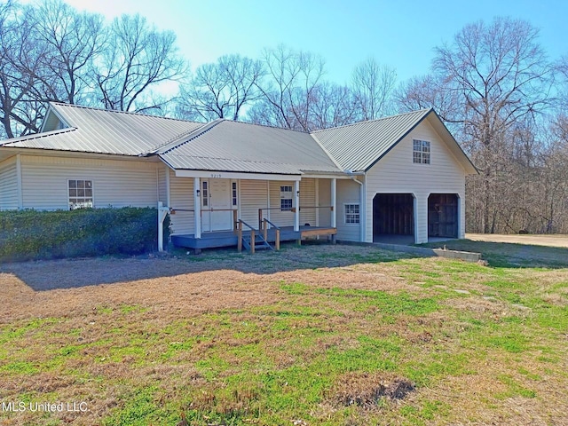 9219 Anding Oil City Rd, Bentonia, MS 39040 - view of front facade with a garage, a porch, metal roof, and a front lawn