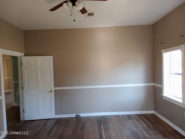 9219 Anding Oil City Rd, Bentonia, MS 39040 - unfurnished room with visible vents, baseboards, dark wood-type flooring, and a ceiling fan