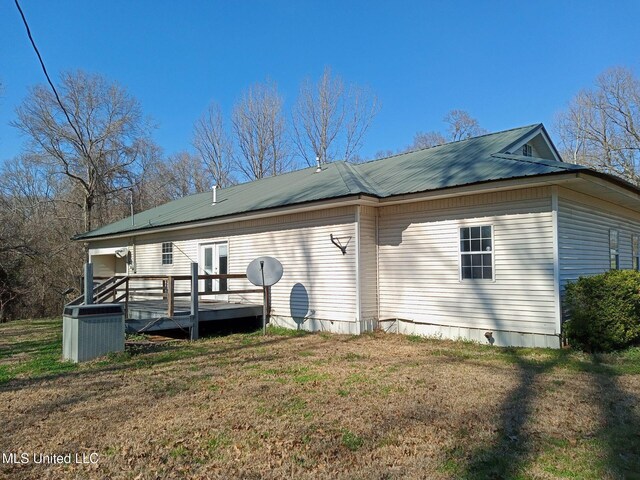 9219 Anding Oil City Rd, Bentonia, MS 39040 - back of property featuring metal roof, a yard, central AC unit, and a deck