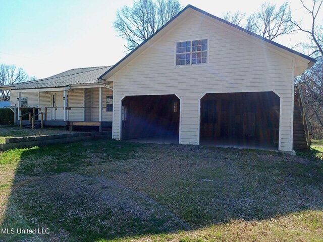 9219 Anding Oil City Rd, Bentonia, MS 39040 - view of front of property featuring a garage, driveway, covered porch, and metal roof