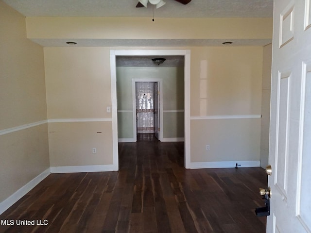9219 Anding Oil City Rd, Bentonia, MS 39040 - empty room with a ceiling fan, dark wood-style floors, and baseboards