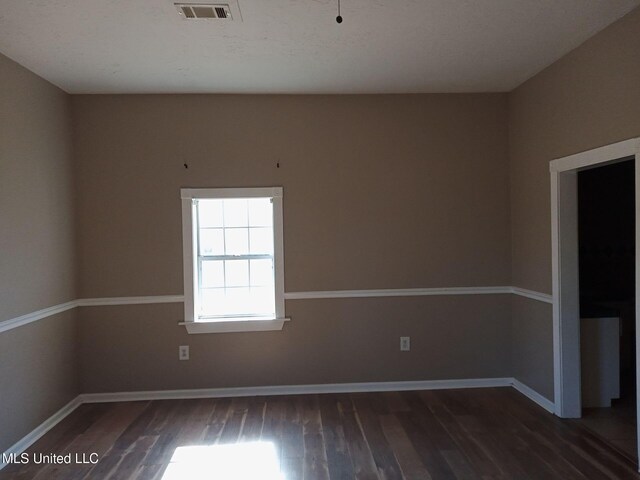 9219 Anding Oil City Rd, Bentonia, MS 39040 - unfurnished room with wood finished floors, visible vents, and baseboards